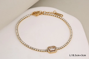 Detail of gold stainless steel bracelet with rectangular zircon and adjustable chain link