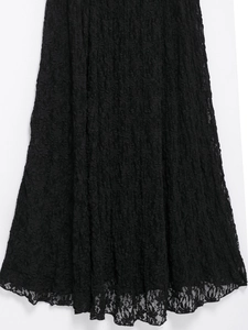 Detailed view of black lace maxi skirt showing intricate textures and scalloped hemline