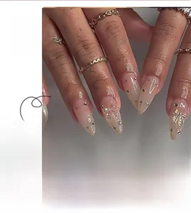 Detailed view of long almond press-on nails with 3D bows, rhinestones and star patterns