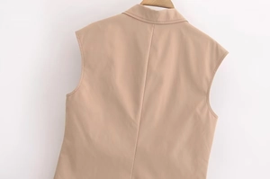 Detail view of the back seam and lapel of a khaki sleeveless blazer vest for women