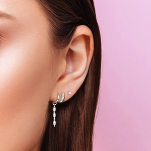 Close-up of S925 silver earring set with pearls and twisted hoop on model