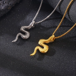 Close-up of gold and silver punk 3D snake pendants with realistic scale textures on chains