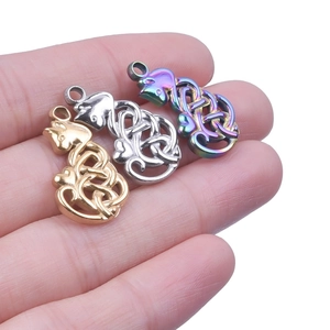 Detailed view of cat-shaped Celtic knot pendants in gold, silver, and rainbow steel