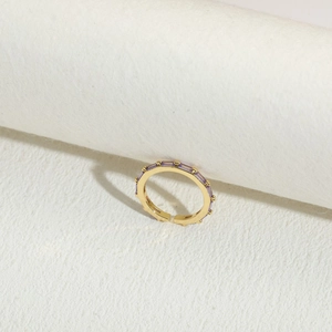 Macro detail of 14K gold plated ring with rectangle lavender zircon in prong setting