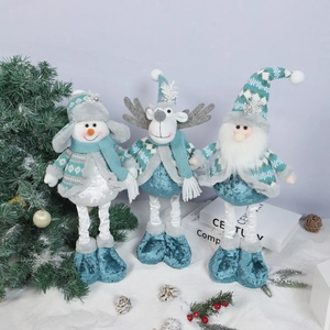 Detail of blue and white Christmas plush dolls snowman reindeer and Santa on snow