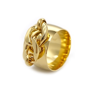 Detail view of a polished gold wide chain link ring with high-gloss finish and modern texture