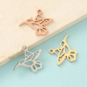 Detailed view of hollow hummingbird pendants in rose gold, silver and gold finishes