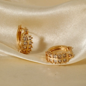 Elegant gold plated hoop earrings with micro-paved cubic zirconia on silk background