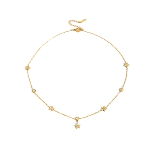 Close-up of gold-plated necklace with star and round charms featuring zircon inlay and lobster clasp