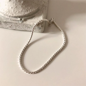Minimalist S925 sterling silver rope chain bracelet displayed on elegant stone base