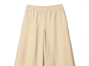 Detail of high-waist beige wide-leg pants with elastic waistband and side pockets