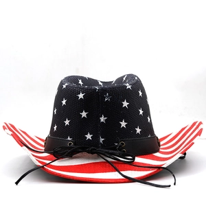 Detail of woven straw cowboy hat featuring American flag patterns and black leather band
