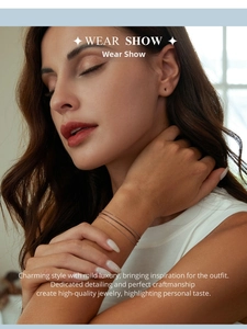 Detail view of a minimalist triple-layer S925 sterling silver beaded bracelet on a wrist