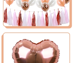 Close-up of rose gold heart foil balloons and matching party tassels for bridal showers