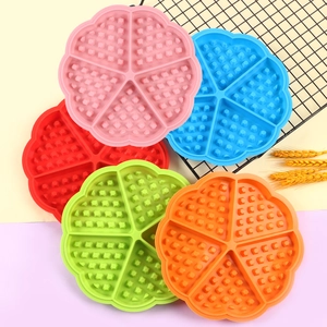 Stack of colorful heart-shaped waffle silicone molds in pink, blue, and green tones