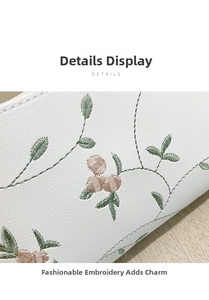 Close-up of elegant floral embroidery on white litchi grain faux leather shoulder bag