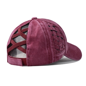 Detail of burgundy ponytail baseball cap featuring elastic criss-cross straps and velcro strap