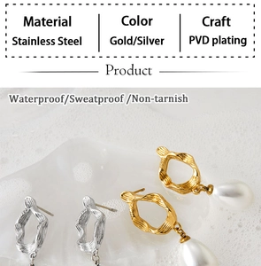 Detail of PVD gold and silver stainless steel earrings with pearls and waterproof coating