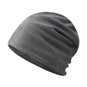 Detail showing the dark grey waffle knit texture and soft drape of the beanie hat