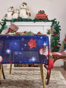 Christmas tablecloth detail featuring Santa and Poinsettia patterns in a festive setting