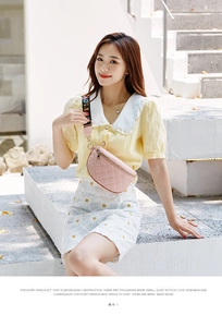 Close-up of pink quilted waist bag with wide colorful woven strap and LOVE text detail
