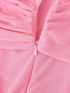Close-up of pink mesh dress featuring a concealed zipper and fine ruched fabric details