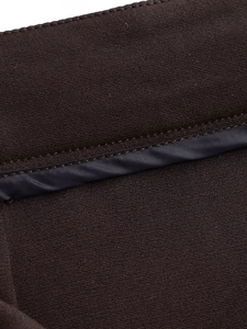 Detail shot of dark brown fabric texture with precise dark grey satin trim stitching