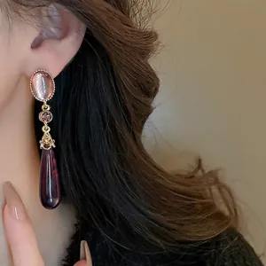 Retro long teardrop earrings with purple resin stones and gold woven texture
