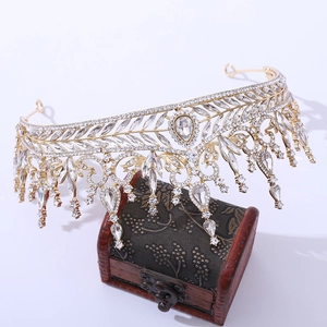Luxurious gold baroque bridal crown with crystals and leaf patterns on vintage box