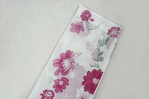 Close-up of lightweight mesh fabric with pink floral print and fine mesh texture details