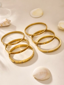 Set of six gold stainless steel hinged bangles with sparkling zircon and clover patterns