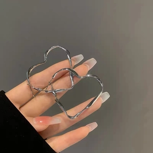 Minimalist silver-toned twisted heart-shaped hoop earrings for women with metallic finish