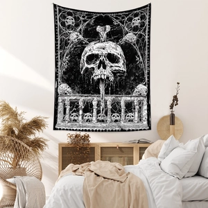 Detailed view of bohemian skull tapestry hanging in a cozy bedroom with high contrast