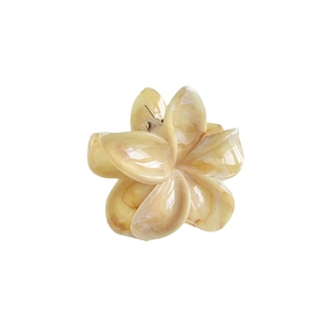 Close-up of 7cm frangipani hair claw clip made of cream acetate with marble texture