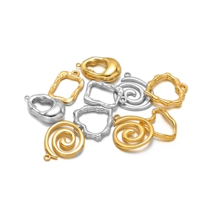 Assorted gold and silver stainless steel pendants in spiral, bamboo, and teardrop shapes