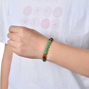 Green crystal and tiger eye beaded bracelet for women shown on a model wrist