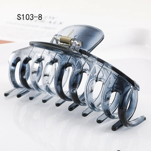 Detail view of large grey-blue gradient hair claw clip showing spring mechanism and texture