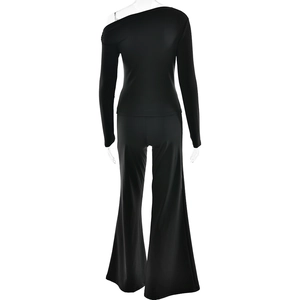 Rear view of sleek black one-shoulder long sleeve top and high-waisted flare trousers set
