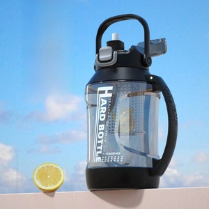 Outdoor low-angle view of sports water bottle with tea infuser filter and carry handle