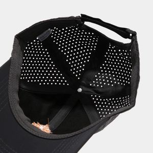 Detail shot of breathable laser-cut mesh interior and sweatband of this black sports cap