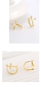 Detail of S925 sterling silver huggie earrings with gold plating and zircon cross