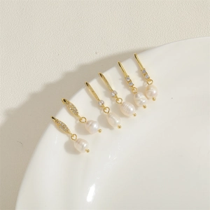 Gold freshwater pearl drop earrings set with zircon accents in vintage baroque style