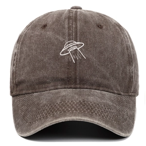 Detail of UFO embroidery on vintage washed brown cotton baseball cap with retro finish