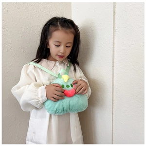 Detail of cute green plush monster backpack with soft texture and 3D features on model