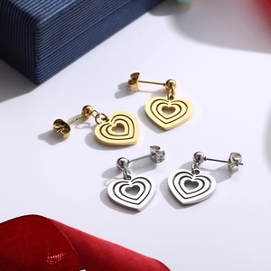 Gold and silver layered heart earrings set in stainless steel with hollow design