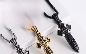 Detailed close-up of gothic skull cross pendants in silver, gold, and black steel
