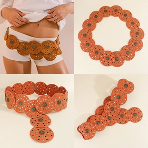 Detail view of orange suede PU belt with bronze rivets and circular metal studs