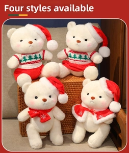 Detail view of four plush Christmas teddy bears in festive sweaters and scarves