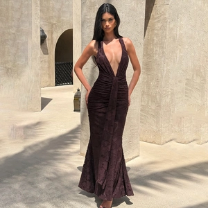 Detail of deep V-neck halter dress in dark brown pleated fabric with a mermaid hem