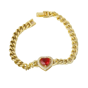 Gold plated cuban link bracelet with a red heart gemstone and zircon halo on white background